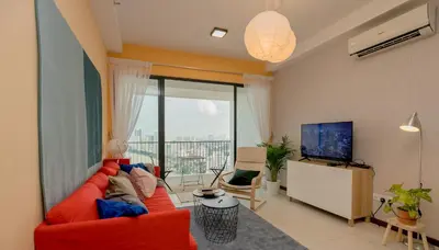a living room with a red couch and a television at The Landmark Condo, by Sanguine in George Town