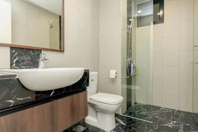 a bathroom with a sink and a toilet and a shower at The Landmark Condo, by Sanguine in George Town
