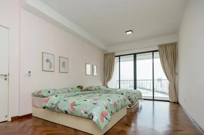 a bedroom with two beds and a large window at The Landmark Condo, by Sanguine in George Town
