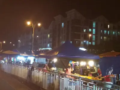 a group of people at an outdoor market at night at Premium Garden Home 17 Golden Hills in Brinchang