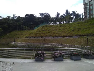 a sign that says golden hills with some plants at Premium Garden Home 17 Golden Hills in Brinchang