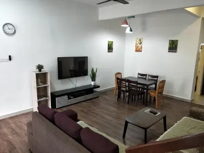 a living room with a couch and a table at Premium Garden Home 17 Golden Hills in Brinchang