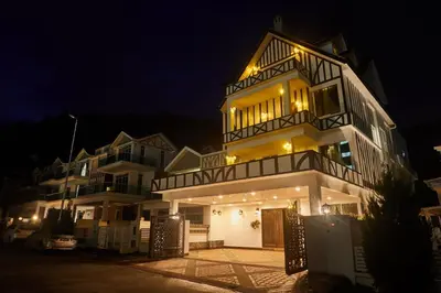 a large white building with lights on it at night at Ahn-Yi Residence in Brinchang