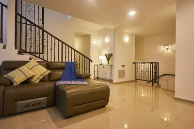 a living room with a couch and a staircase at Ahn-Yi Residence in Brinchang