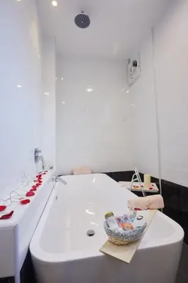 a white bath tub with a bowl on top of it at Ahn-Yi Residence in Brinchang