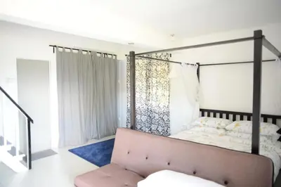 a bedroom with a bed and a couch at Tiny Boutique Habitat in Tanah Rata