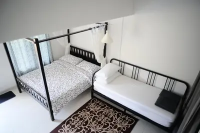 a bedroom with two bunk beds and a rug at Tiny Boutique Habitat in Tanah Rata