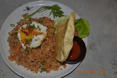 a plate of food with fried rice and a tortilla at Hotel Seri Malaysia Sungai Petani in Sungai Petani