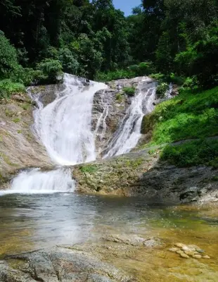 a waterfall in the middle of a river at Strawberry Park Resort in Cameron Highlands