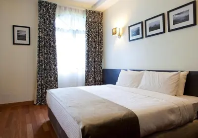 a bedroom with a large bed and a window at Strawberry Park Resort in Cameron Highlands