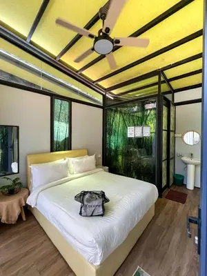 a bedroom with a large bed with a ceiling fan at Xscape Tambun in Ipoh
