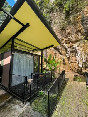 a building with a yellow roof and a fence at Xscape Tambun in Ipoh