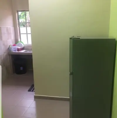 a green refrigerator in a kitchen with a sink at Teratak Nipah Homestay Teluk Nipah Pangkor in Pangkor
