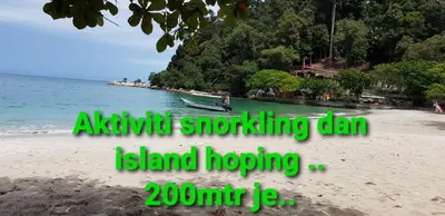 an image of a beach with a boat in the water at Teratak Nipah Homestay Teluk Nipah Pangkor in Pangkor