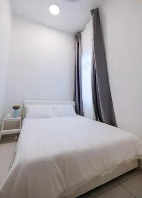 a bedroom with a white bed with a window at Comfy Sofy 21- Backyard Garden- Night Market area in Cameron Highlands