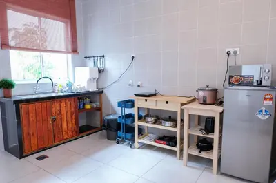 a kitchen with a sink and a refrigerator at Comfy Sofy 21- Backyard Garden- Night Market area in Cameron Highlands