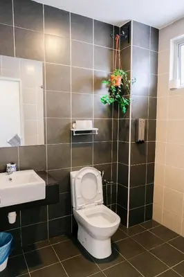 a bathroom with a toilet and a sink at Comfy Sofy 21- Backyard Garden- Night Market area in Cameron Highlands