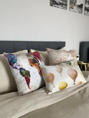a couch with pillows with a map of the world at SUNRISE Gurney Seaview Luxury Duplex in George Town