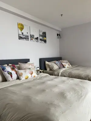 a room with two beds and a couch in it at SUNRISE Gurney Seaview Luxury Duplex in George Town