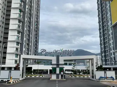 a sign for a parking lot in front of two tall buildings at 2BR The Yeop Ipoh Homestay Apartment Casa Kayangan Bandar Meru Raya in Ipoh