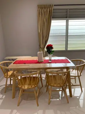 a dining room table with chairs and a table with a vase of flowers at Traditional Villa with Modern Design 3R2B in Ipoh