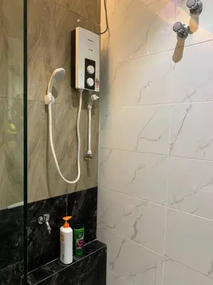a shower in a bathroom with a phone on the wall at Traditional Villa with Modern Design 3R2B in Ipoh