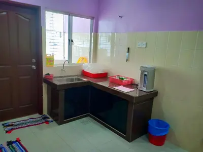 a kitchen with a sink and a counter top at Purple TownHouse 9pax 3R2B Wifi in Sekincan