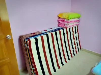 a pile of towels sitting on top of a suitcase at Purple TownHouse 9pax 3R2B Wifi in Sekincan