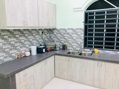 a kitchen with a sink and a counter top at Atocha Homestay - Terong@Taiping in Kampong Salak
