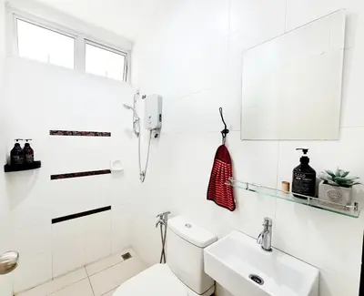 a white bathroom with a toilet and a sink at Ocean 25 Shamrock Beach Big Group 6 Bedroom 5 Bathroom with Pool in Tanjung Bungah