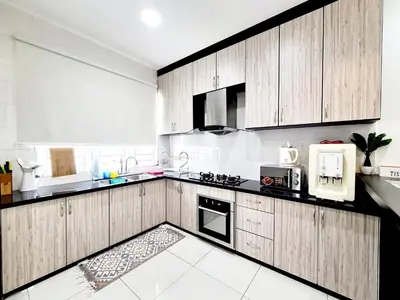 a large kitchen with wooden cabinets and appliances at Ocean 25 Shamrock Beach Big Group 6 Bedroom 5 Bathroom with Pool in Tanjung Bungah