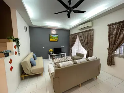 a living room with a couch and a ceiling fan at Ipoh Station 18 in Ipoh