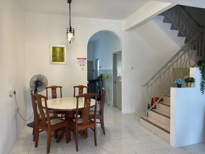 a dining room with a table and chairs and stairs at Ipoh Station 18 in Ipoh