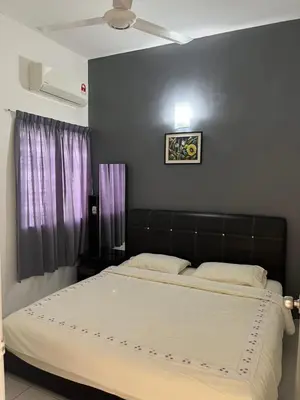 a bed with a black headboard in a bedroom at Ipoh Station 18 in Ipoh