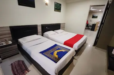 two beds in a hotel room withthritisthritislictslictslicts at Heaven Mountain Hill Hotel 1 Cameron Highlands in Cameron Highlands