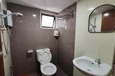 a bathroom with a toilet and a sink and a mirror at Heaven Mountain Hill Hotel 1 Cameron Highlands in Cameron Highlands
