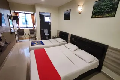 two beds in a room with a red and white blanket at Heaven Mountain Hill Hotel 1 Cameron Highlands in Cameron Highlands