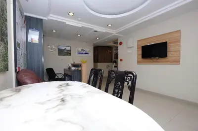 a dining room with a table and chairs and a tv at Heaven Mountain Hill Hotel 1 Cameron Highlands in Cameron Highlands