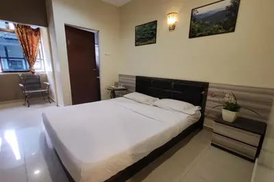 a bedroom with a large bed and a chair at Heaven Mountain Hill 2 Cameron Highlands in Cameron Highlands
