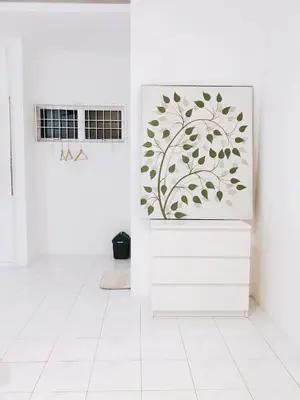 a white room with a door with a painting on it at 22 Haus in Bukit Mertajam