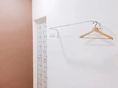 a bathroom with a shower curtain and a hanger at 22 Haus in Bukit Mertajam