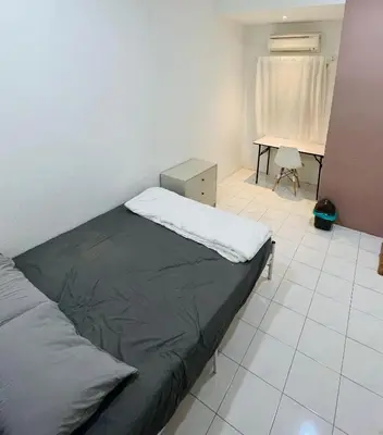 a bedroom with a bed and a desk in it at 22 Haus in Bukit Mertajam