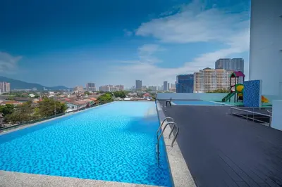 a swimming pool on the roof of a building at Avatel Jelutong PWCC in George Town