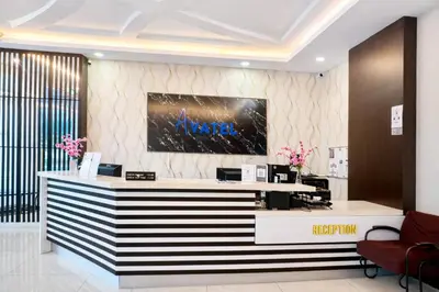 a lobby with a reception desk in a building at Avatel Jelutong PWCC in George Town