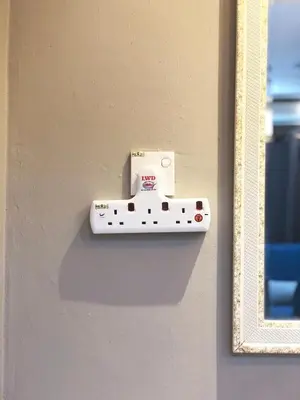 a white object on a wall with a socket at Homestay Cahaya 2 Seri Iskandar in Seri Iskandar