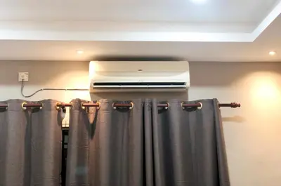 a room with a heater and a curtain at Homestay Cahaya 2 Seri Iskandar in Seri Iskandar