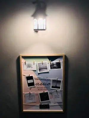 a bulletin board on a wall with pictures on it at Homestay Cahaya 2 Seri Iskandar in Seri Iskandar