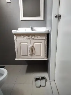 a bathroom with a sink and two shoes on the floor at Kampar Champs Elysees, King Bed Studio unit 12A21 in Kampar