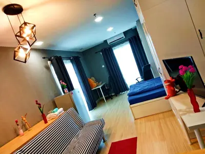 a living room with a bed and a mirror at Kampar Champs Elysees, King Bed Studio unit 12A21 in Kampar