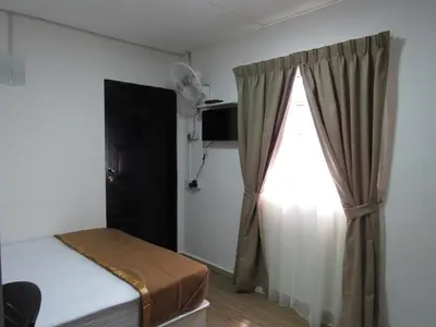 a room with a bed and a window with a curtain at Darulmakmur Chalet in Cameron Highlands